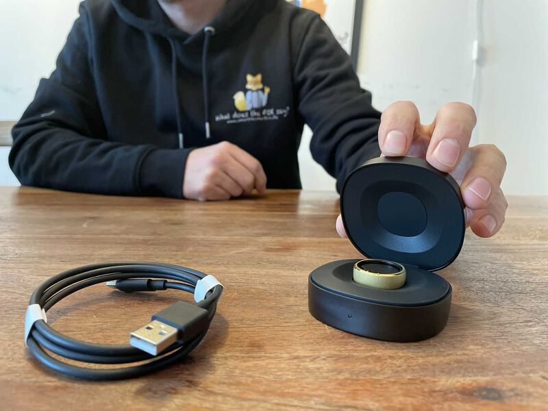 RingConn smart ring and charging case on the table.