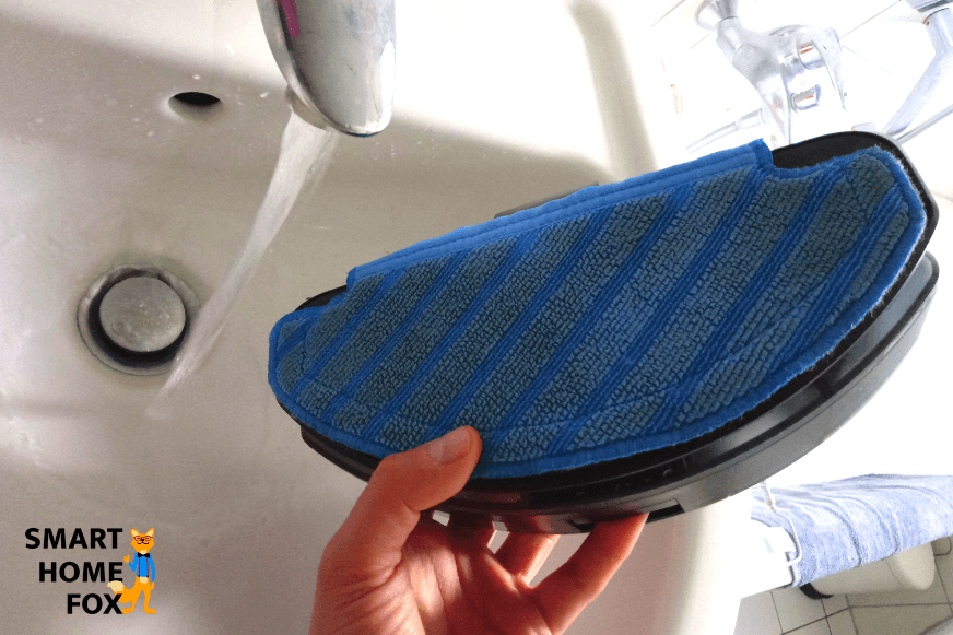 Dampening the Deebot OZMO T8 AIVI's wiping cloth before the cleaning run.