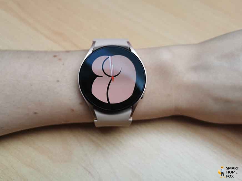 The watch face of a smartwatch is visible.