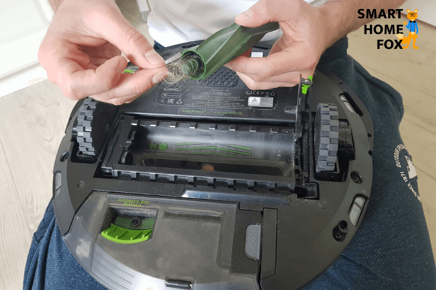 Tangled hair is pulled out of the iRobot Roomba's rubber brushes.