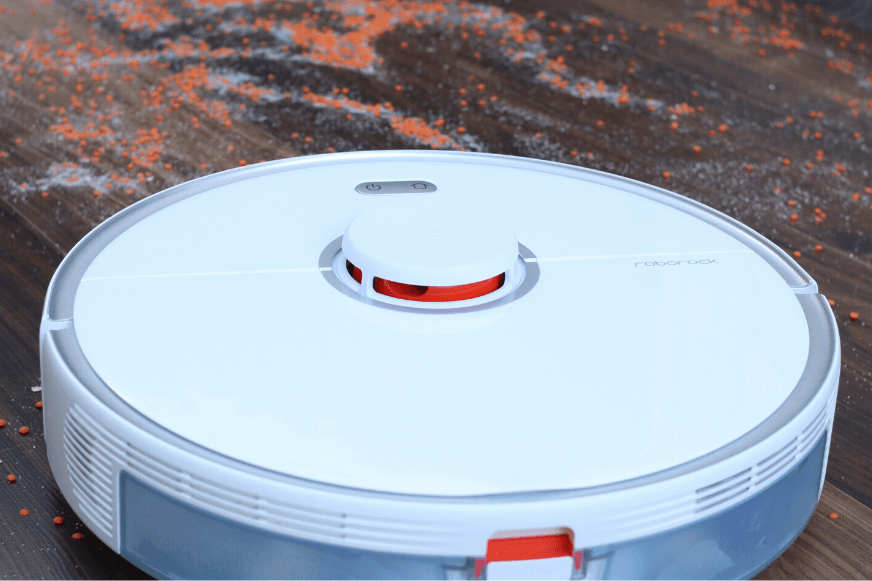Roborock S5 Max vacuums lentils and sand on a hard floor